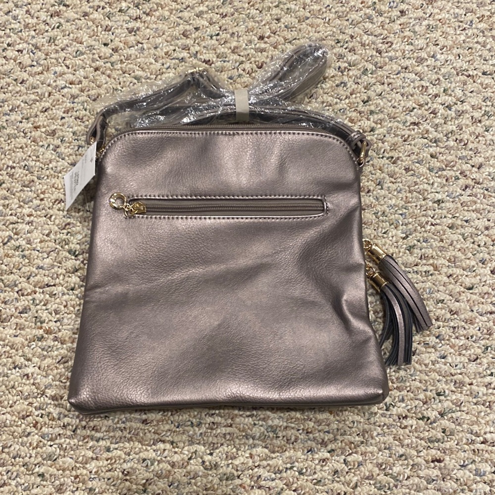 Pewter cross body bag. Never been used, straps are still wrapped and tags.